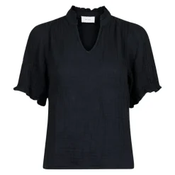 Blusa in lino nero con dettagli a balze